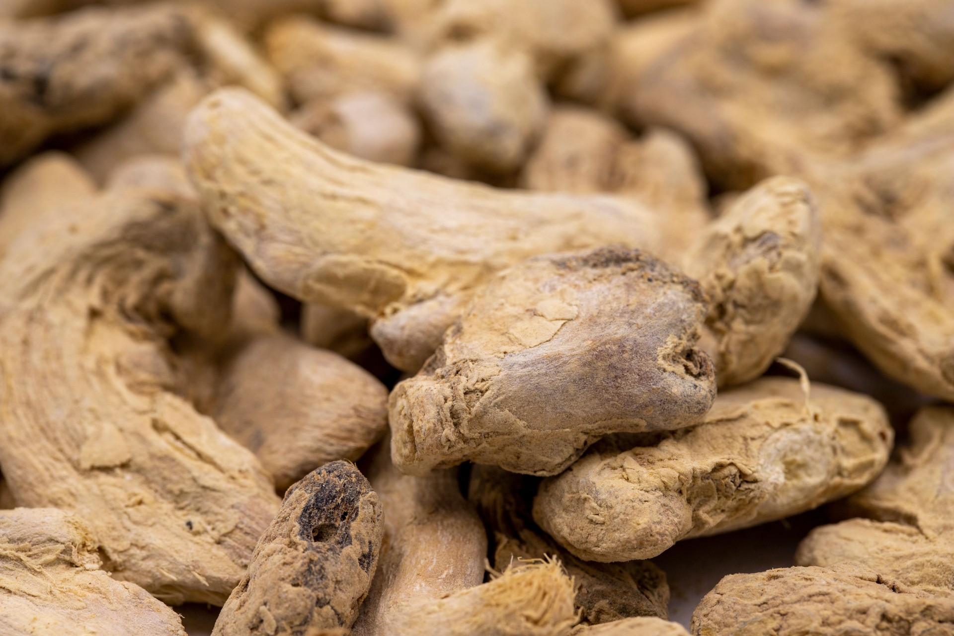 Pile of Dried Ginger root as background, spice or seasoning as background. Close-up ginger root or Dry Adrak