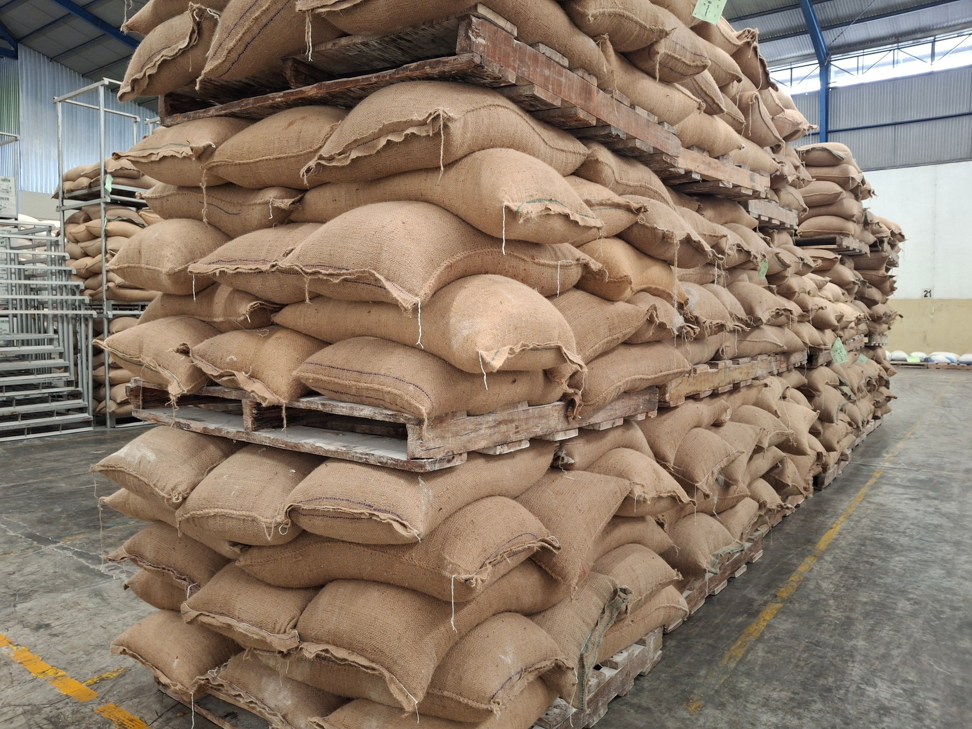 arrangement of flour sacks in the warehouse area, raw materials warehouse, piles of food sacks, arrangement of goods in the warehouse area